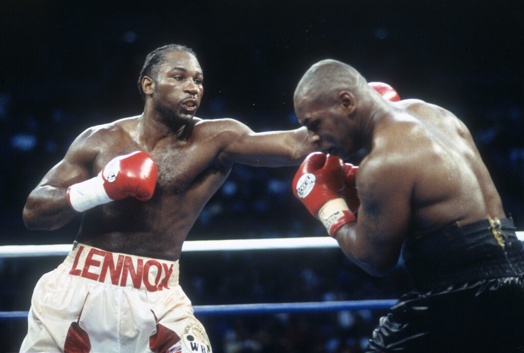Lennox Lewis hits a left jab on Mike Tyson during their 2002 fight