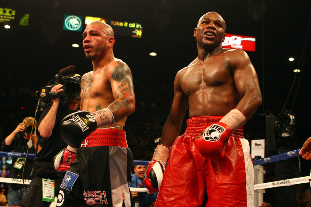 Miguel Cotto in the ring with Floyd Mayweather after their 2012 welterweight title fight