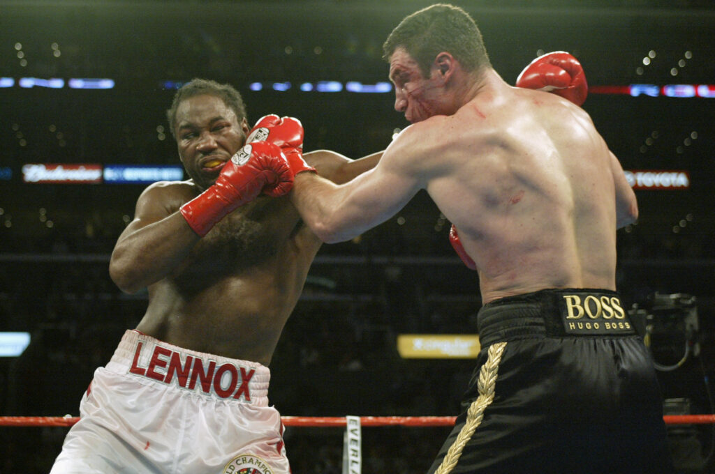 Vitali Klitschko punches Lennox Lewis during their heavyweight title fight in 2003
