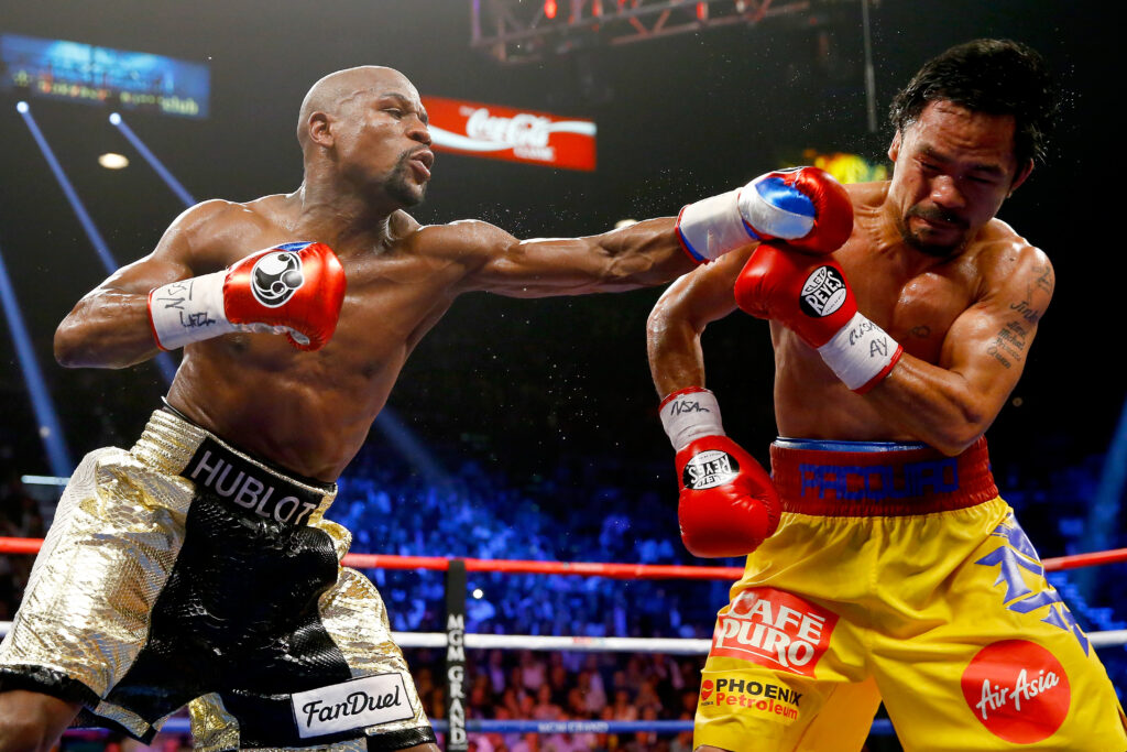 Floyd Mayweather throws a punch at Manny Pacquiao during their welterweight championship fight in 2015