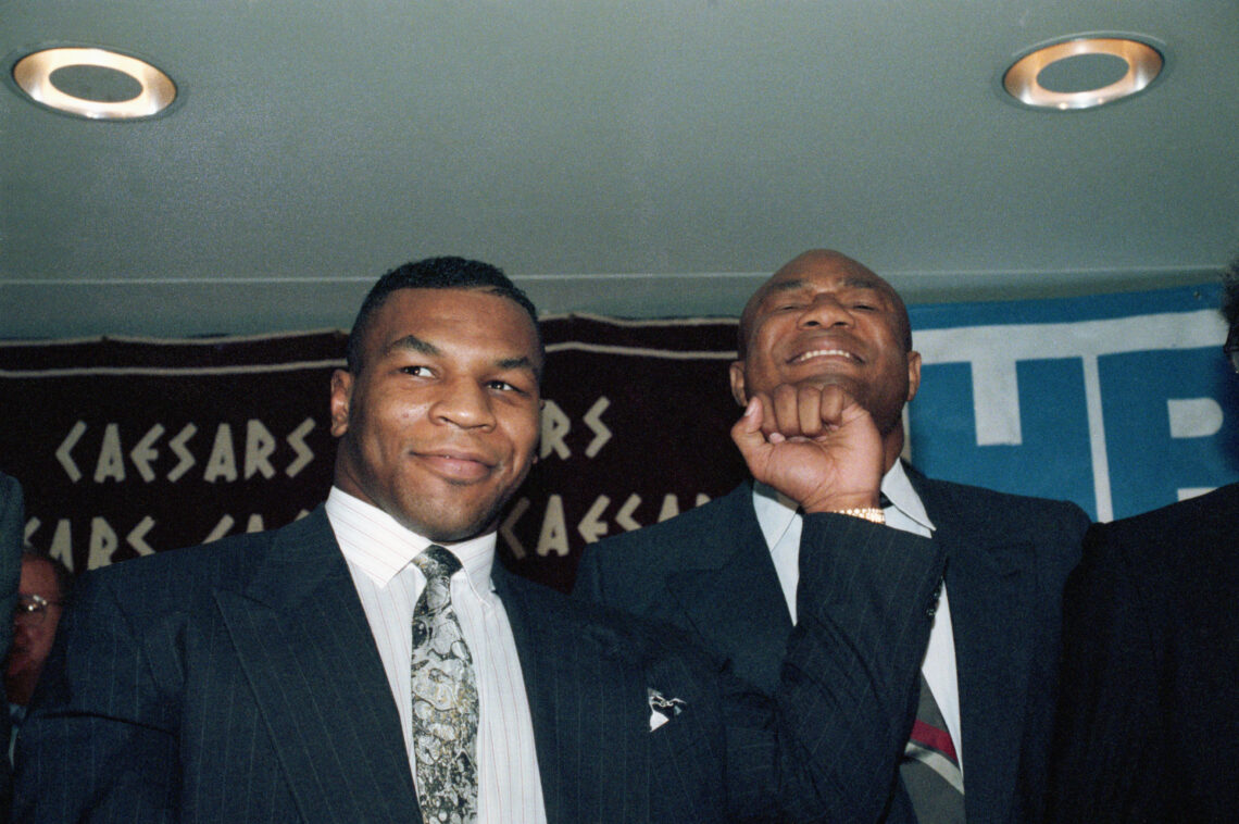 (Original Caption) 4/30/1990-New York, New York- Former world heavyweight champions Mike Tyson, (L), and George Foreman will appear on the same car...
