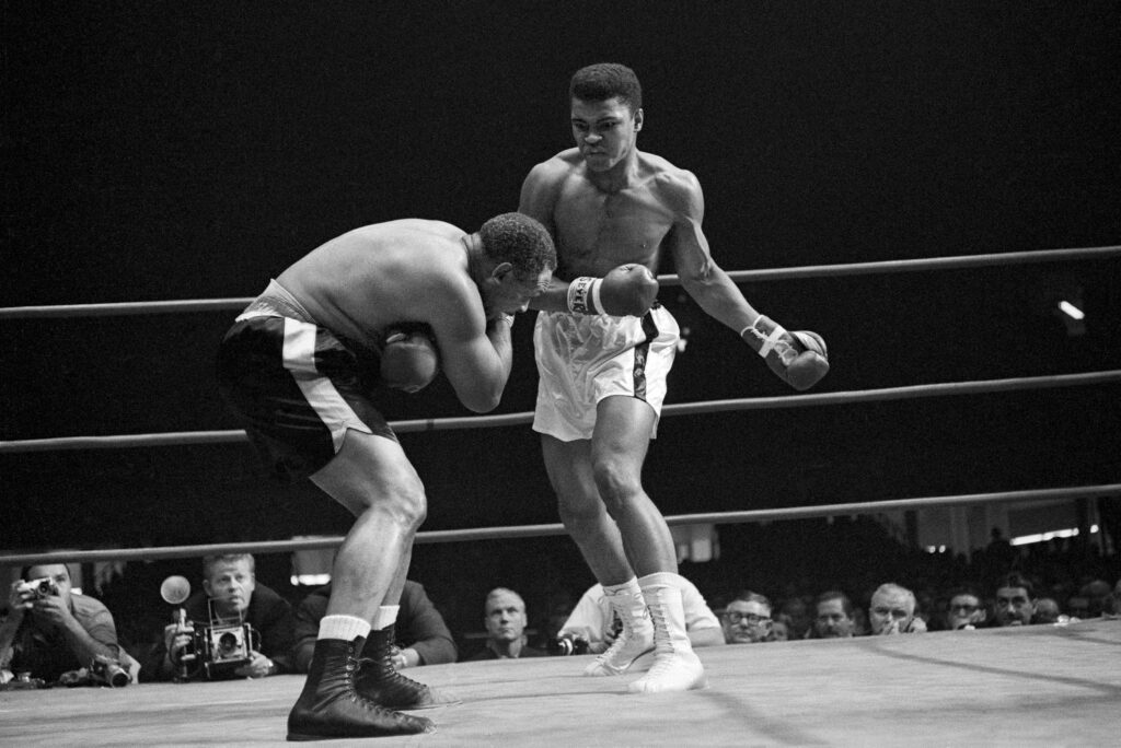 Muhammad Ali prepares to throw a left uppercut at Archie Moore