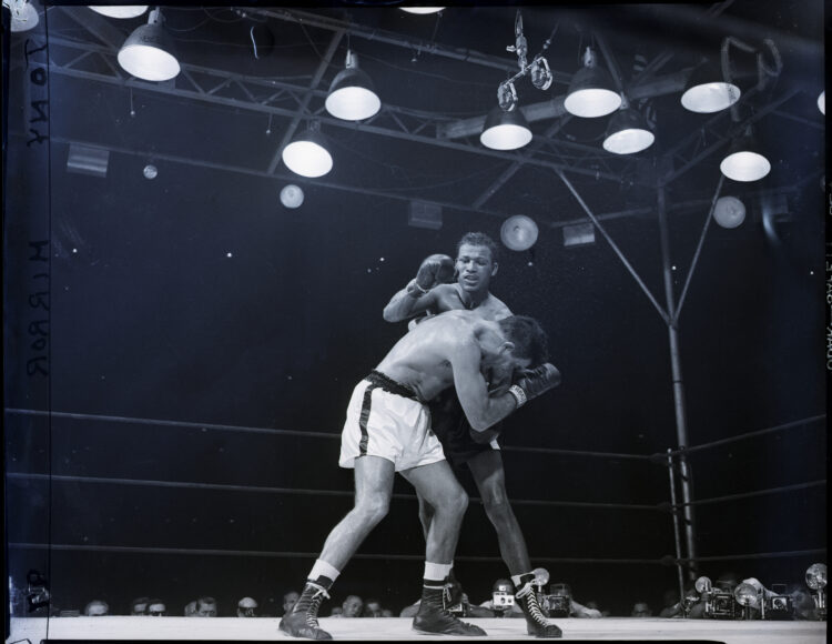 (Original Caption) 6/25/1952-New York, NY- Sugar Ray Robinson lands a long right to the stomach of light-heavyweight champion Joey Maxim (L) during...