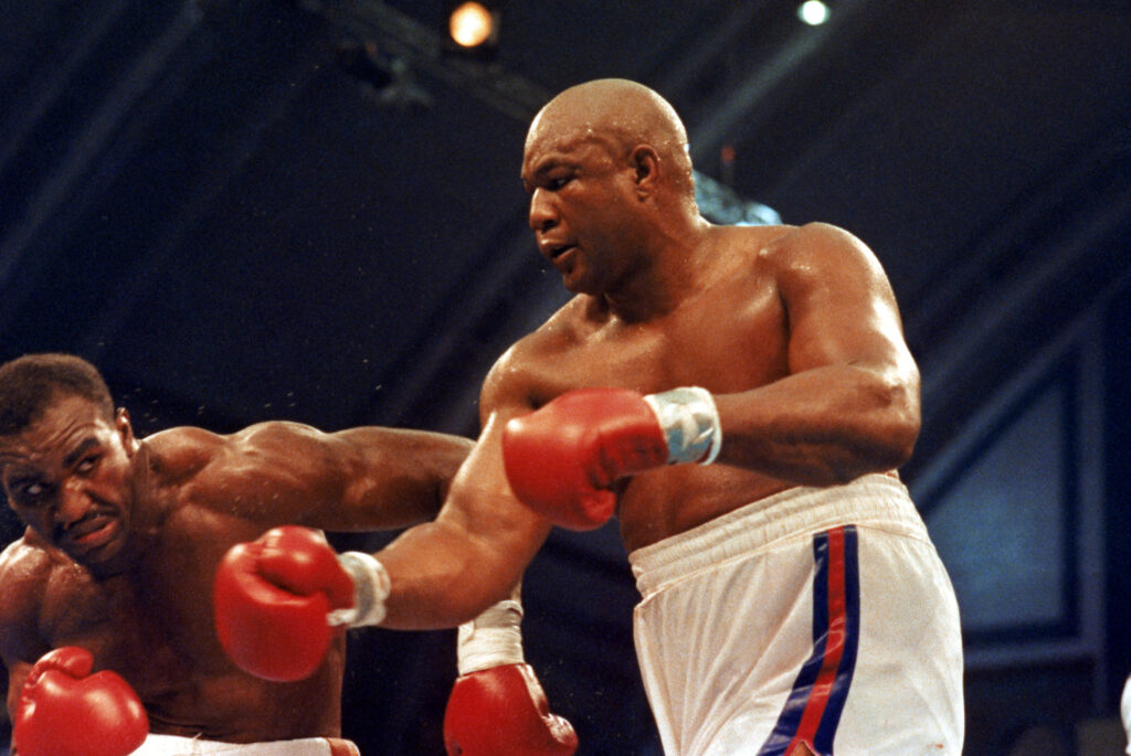 Evander Holyfield avoids a right hook from George Foreman during their 1991 heavyweight title fight in Atlantic City