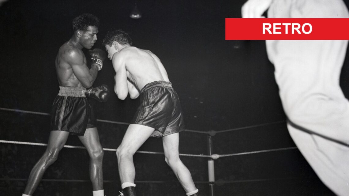 Sugar Ray Robinson hits Jimmy Doyle with a body shot